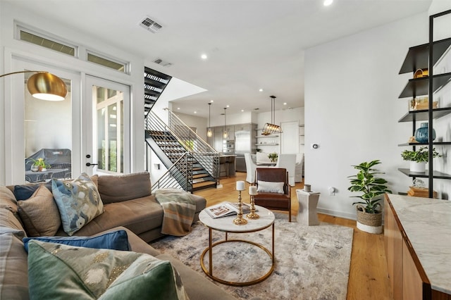 living room featuring light hardwood / wood-style floors and french doors