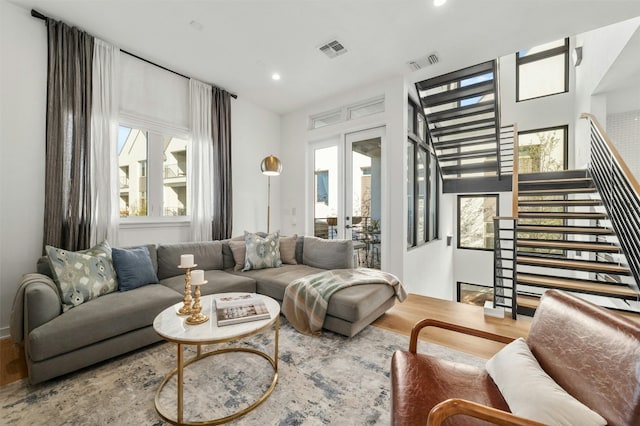 living room featuring hardwood / wood-style floors, a wealth of natural light, and french doors