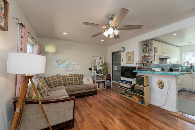 living room with hardwood / wood-style floors and ceiling fan