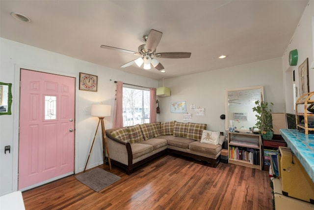 living room with dark wood-type flooring and ceiling fan