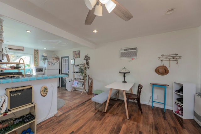 interior space featuring a wall mounted air conditioner, wood-type flooring, and ceiling fan