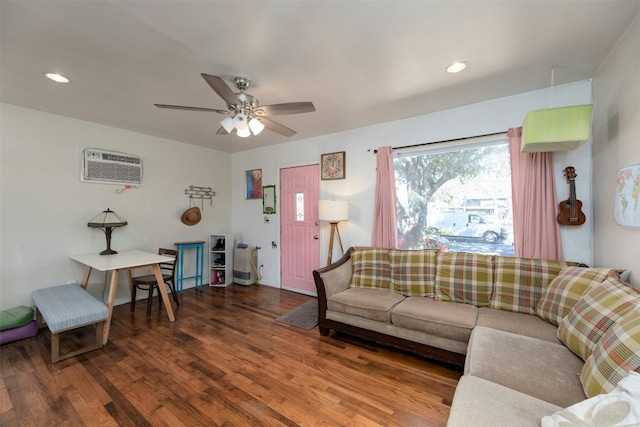 living room featuring ceiling fan, a wall mounted air conditioner, and wood-type flooring