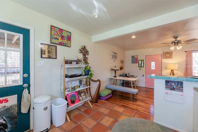 kitchen featuring ceiling fan, beam ceiling, and light tile patterned floors