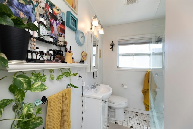 bathroom featuring walk in shower, vanity, and toilet