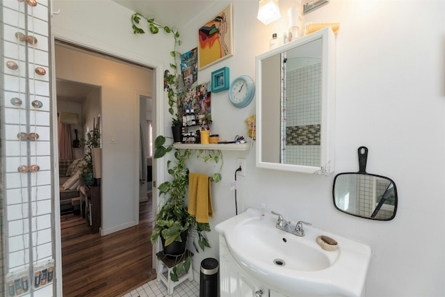 bathroom with hardwood / wood-style flooring and vanity