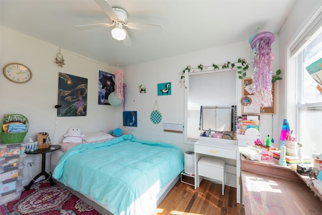 bedroom with ceiling fan and dark hardwood / wood-style flooring