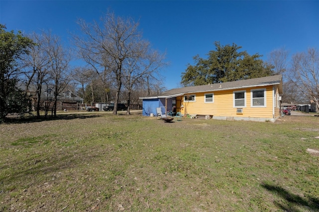 rear view of property with a lawn