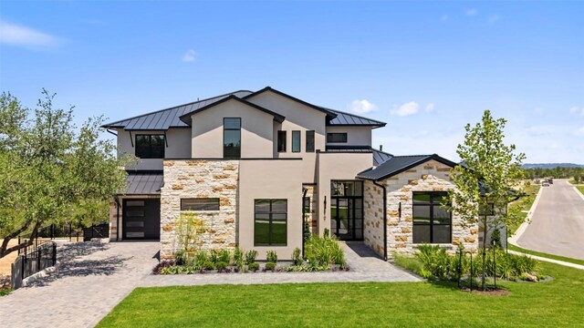 6101 Adhara Pass, Austin, TX 78730 - modern home featuring a standing seam roof, stone siding, a metal roof, and a front yard