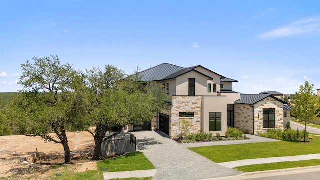 6101 Adhara Pass, Austin, TX 78730 - contemporary house featuring a standing seam roof, stone siding, stucco siding, and decorative driveway