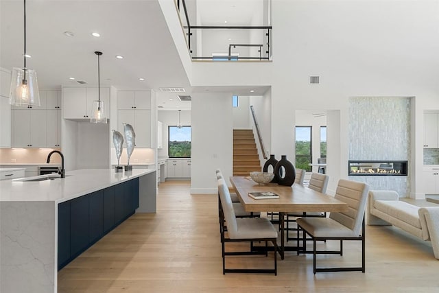 6101 Adhara Pass, Austin, TX 78730 - dining area featuring stairway, light wood finished floors, healthy amount of natural light, and recessed lighting