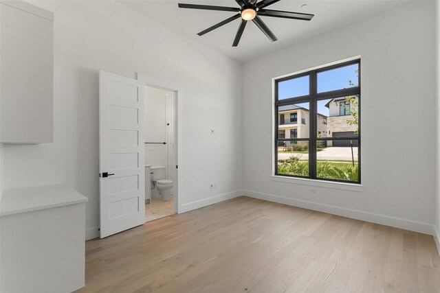6101 Adhara Pass, Austin, TX 78730 - unfurnished bedroom featuring light wood finished floors, ensuite bath, and a ceiling fan