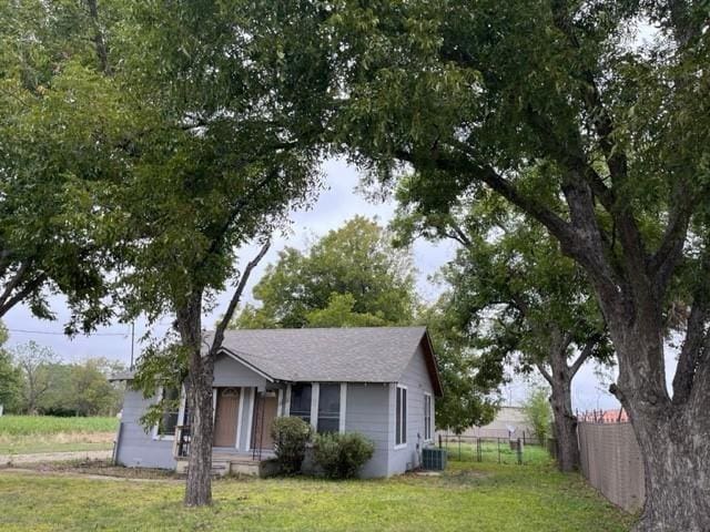 view of front of house featuring a front yard and central air condition unit