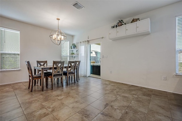 tiled dining space with an inviting chandelier