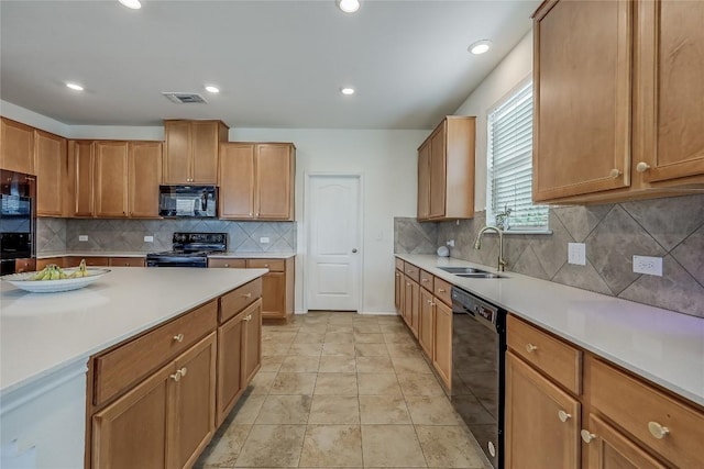 kitchen featuring sink, light tile patterned floors, backsplash, and black appliances