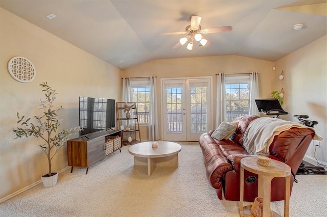 living room featuring lofted ceiling, a wealth of natural light, carpet floors, and french doors