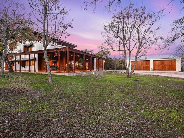 yard at dusk featuring an outbuilding