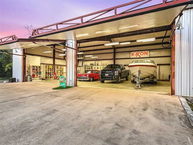 view of garage at dusk