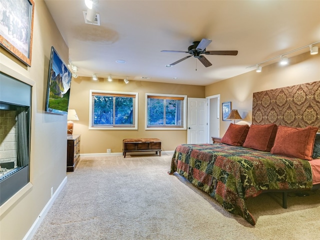 carpeted bedroom featuring track lighting