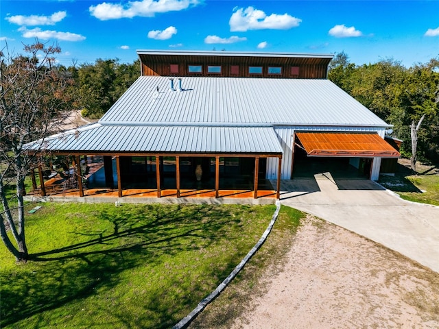 exterior space featuring metal roof and concrete driveway