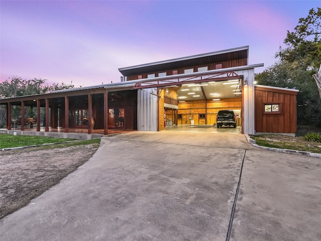 exterior space featuring board and batten siding, an outdoor structure, and a garage