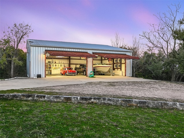 outdoor structure at dusk with a yard and an outdoor structure