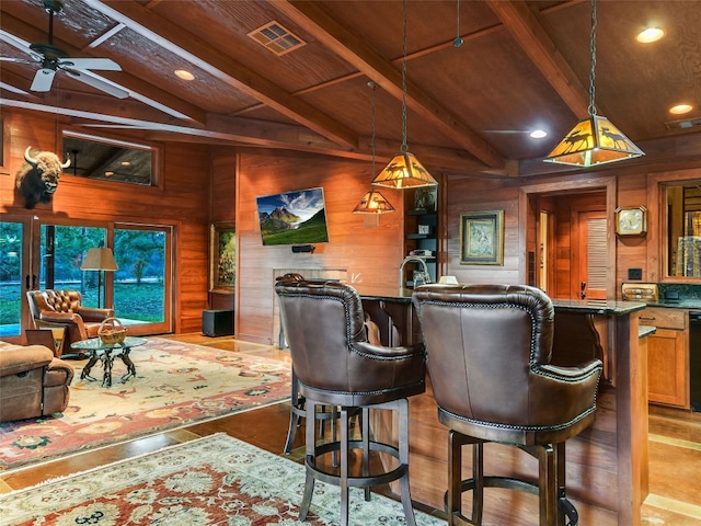 bar with decorative light fixtures, visible vents, lofted ceiling with beams, wooden walls, and wooden ceiling