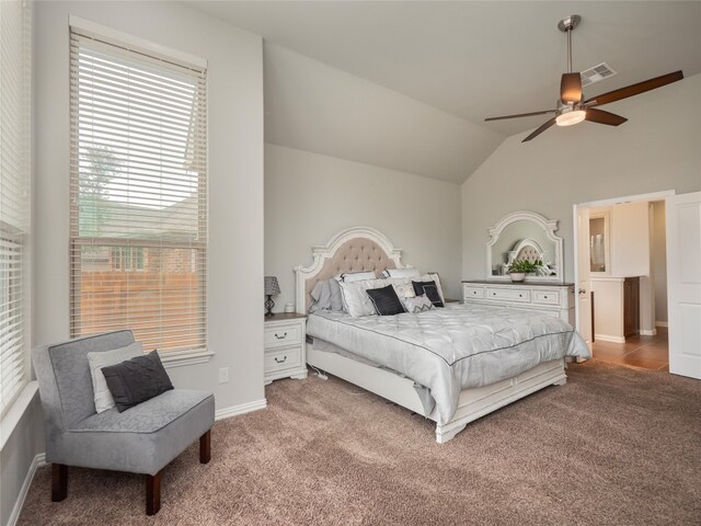 carpeted bedroom featuring vaulted ceiling and ceiling fan