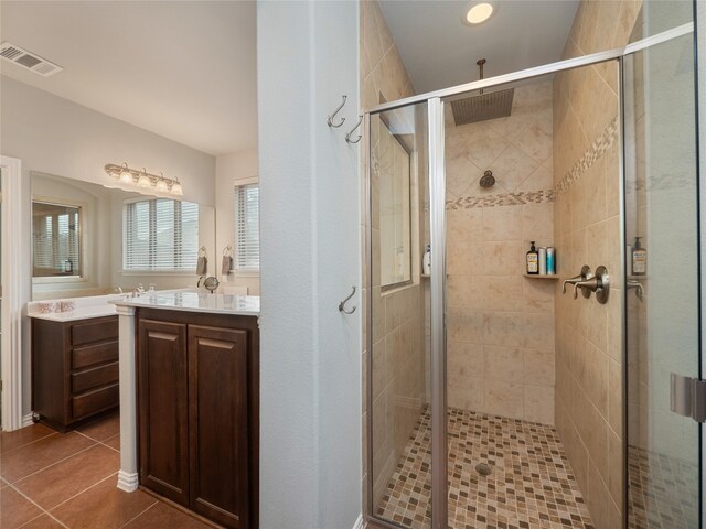 bathroom with vanity, tile patterned flooring, and a shower with shower door