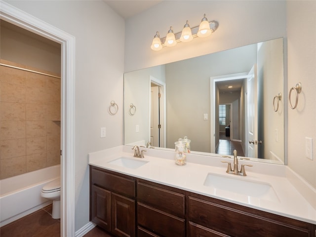 full bathroom with tiled shower / bath combo, toilet, tile patterned flooring, and vanity