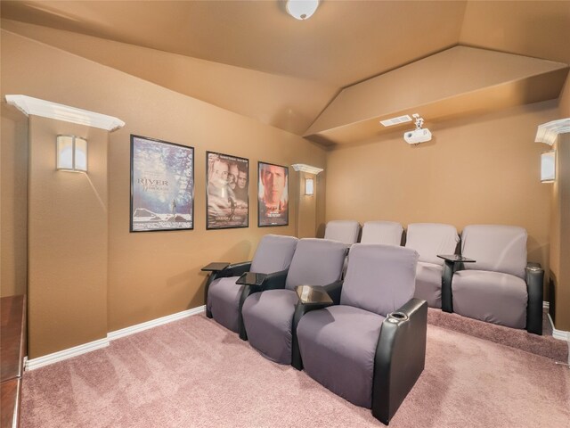 carpeted cinema room with lofted ceiling