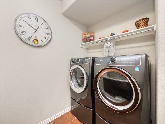 laundry area featuring washer and clothes dryer and tile patterned floors