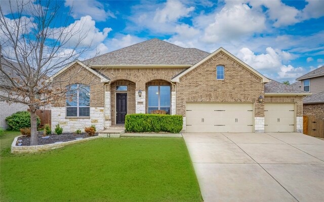 view of front of house featuring a garage and a front yard