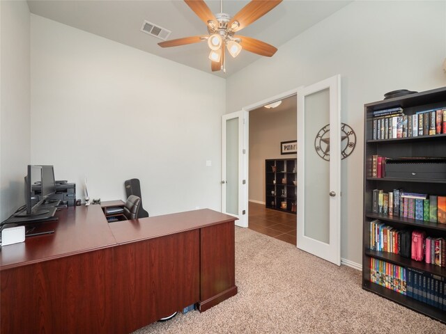 carpeted office space with ceiling fan and french doors