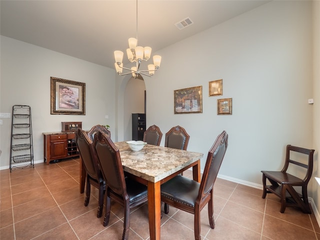 tiled dining room featuring a notable chandelier