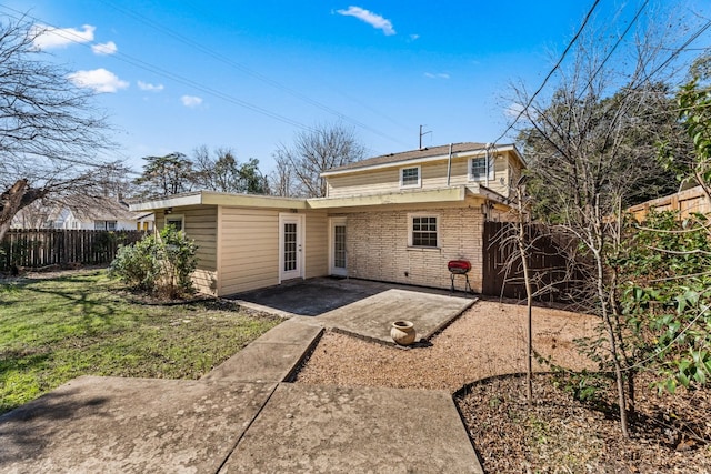 rear view of house featuring a patio and a lawn