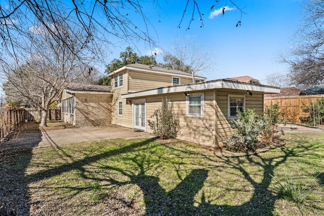 rear view of property with a lawn and a patio area