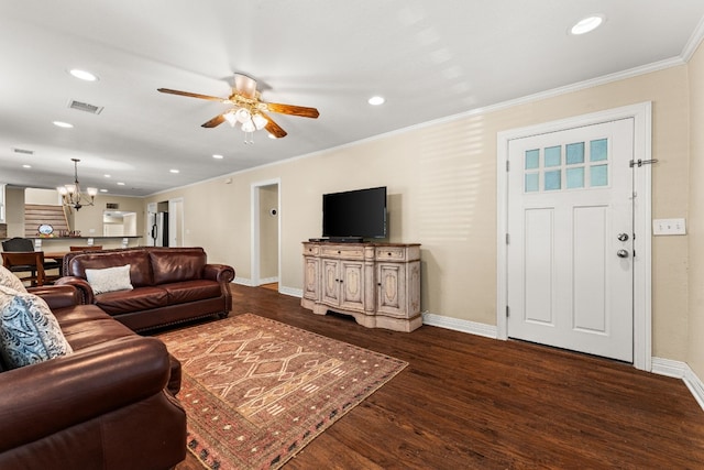 living room with ceiling fan with notable chandelier, dark wood-type flooring, and ornamental molding