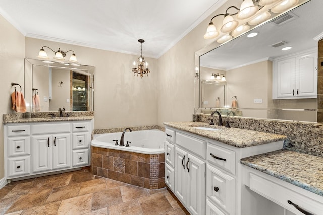 bathroom featuring vanity, tiled tub, crown molding, and a chandelier