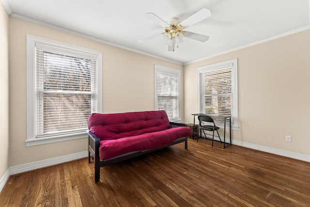 living area with ornamental molding, dark hardwood / wood-style floors, and ceiling fan