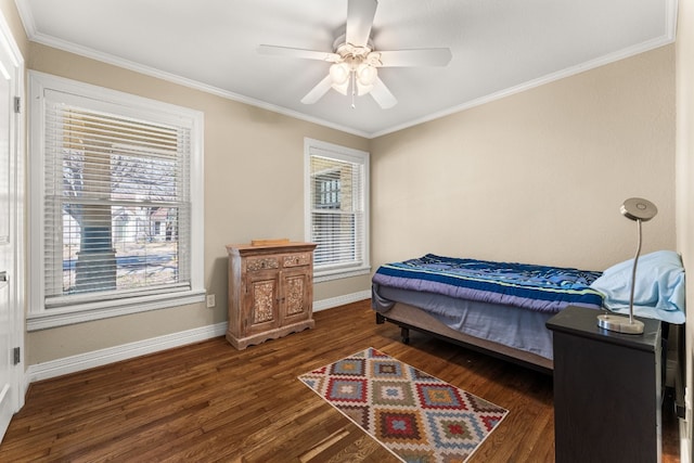 bedroom featuring crown molding, dark wood-type flooring, and ceiling fan