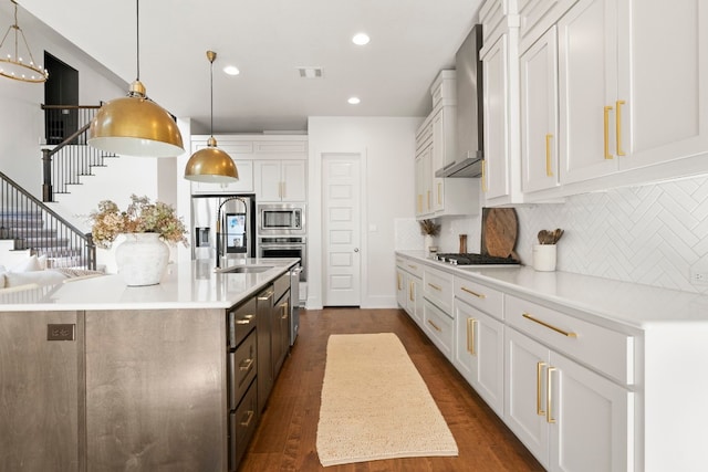 kitchen with stainless steel appliances, decorative light fixtures, and white cabinets