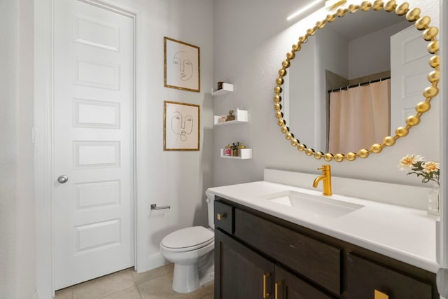 bathroom with tile patterned floors, toilet, and vanity