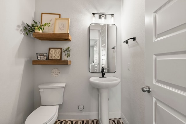 bathroom featuring sink and toilet