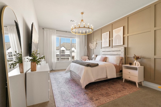 carpeted bedroom featuring a notable chandelier