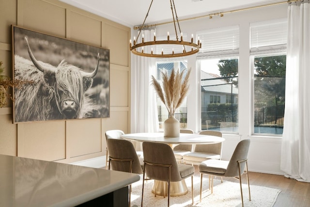 dining area with an inviting chandelier and light wood-type flooring