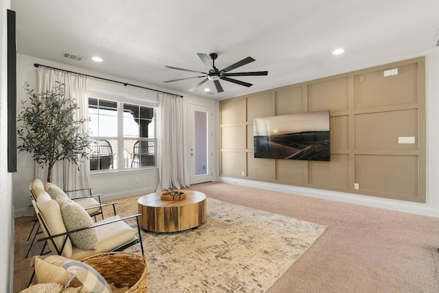 living room with carpet and ceiling fan