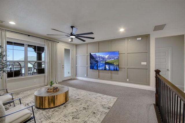 living area with a ceiling fan, baseboards, visible vents, and carpet flooring