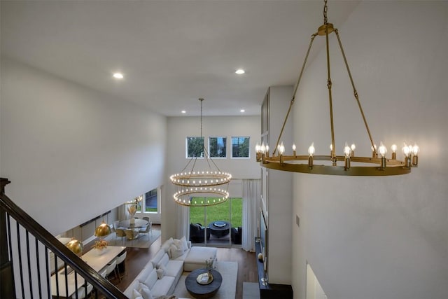 interior space featuring a towering ceiling, wood finished floors, and recessed lighting