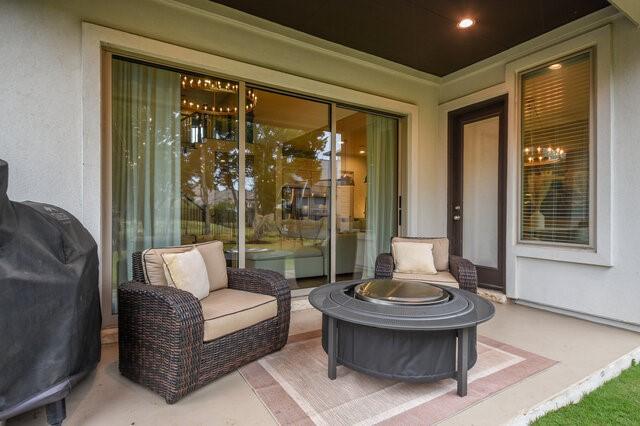 view of patio with an outdoor living space with a fire pit and a grill