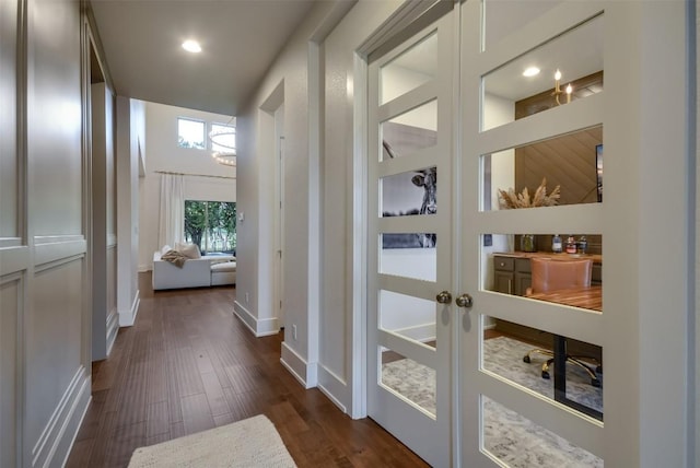 doorway to outside with french doors, dark wood finished floors, and baseboards